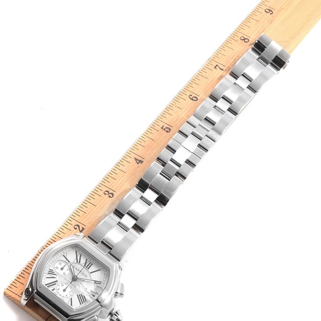 The image shows the Cartier Roadster W62019X6 Men's Stainless Steel Silver Dial W62019X6 Men's Stainless Steel Silver Dial watch face and bracelet from a top-down angle, measuring the bracelet's length against a ruler.