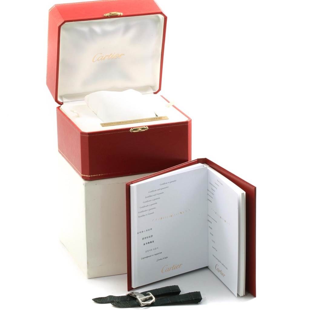 The image shows an open red Cartier watch box, a booklet, and an additional strap for the Cartier Roadster W6206012 Men
s Stainless Steel Blue Dial W6206012 Men
s Stainless Steel Blue Dial model.