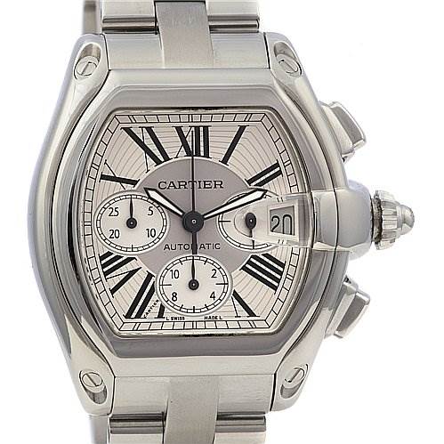 The image shows a frontal view of a Cartier Roadster W62019X6 Men's Stainless Steel Silver Dial W62019X6 Men's Stainless Steel Silver Dial watch, highlighting its dial, chronograph subdials, and date window.