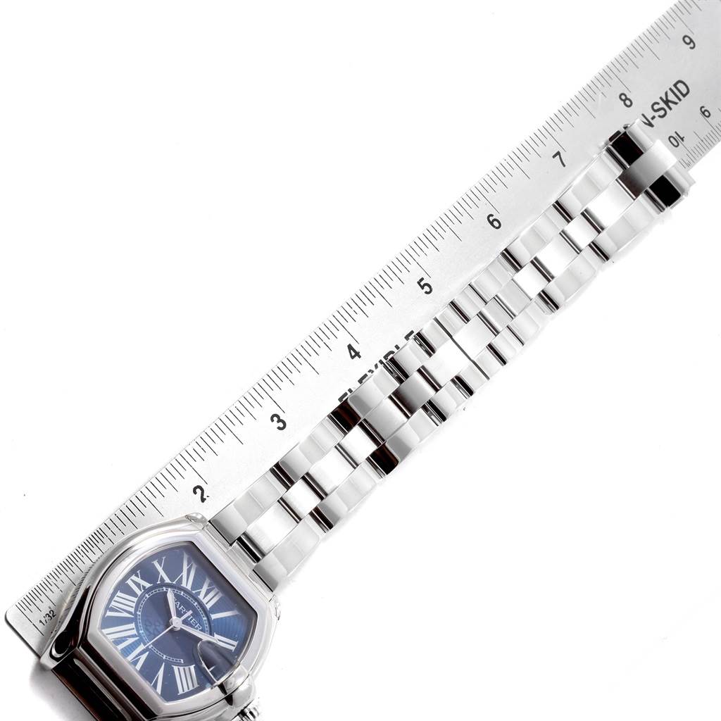 The image shows a Cartier Roadster W6206012 Men
s Stainless Steel Blue Dial W6206012 Men
s Stainless Steel Blue Dial watch from an aerial view, aligned with a ruler to measure its bracelet length.