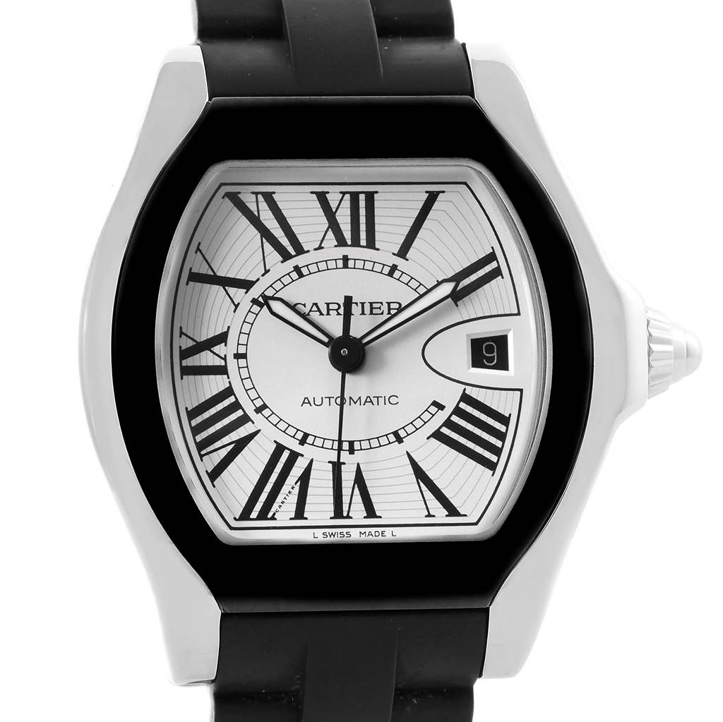 The image shows a close-up of the Cartier Roadster W6206018 Men
s Stainless Steel Silver Dial W6206018 Men
s Stainless Steel Silver Dial watch face and bezel featuring Roman numerals and a date window.