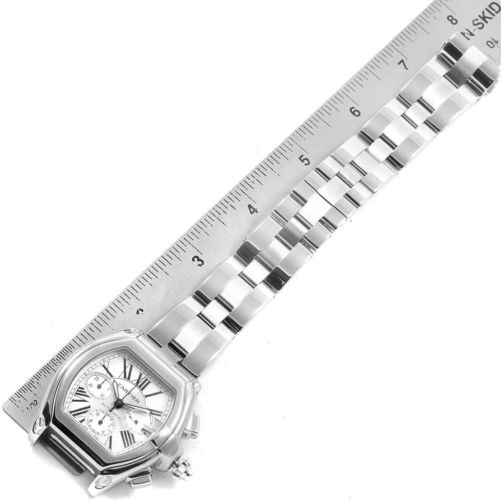 The image shows the face and bracelet of a Cartier Roadster W62019X6 Men's Stainless Steel Silver Dial W62019X6 Men's Stainless Steel Silver Dial watch, positioned next to a ruler for scale.