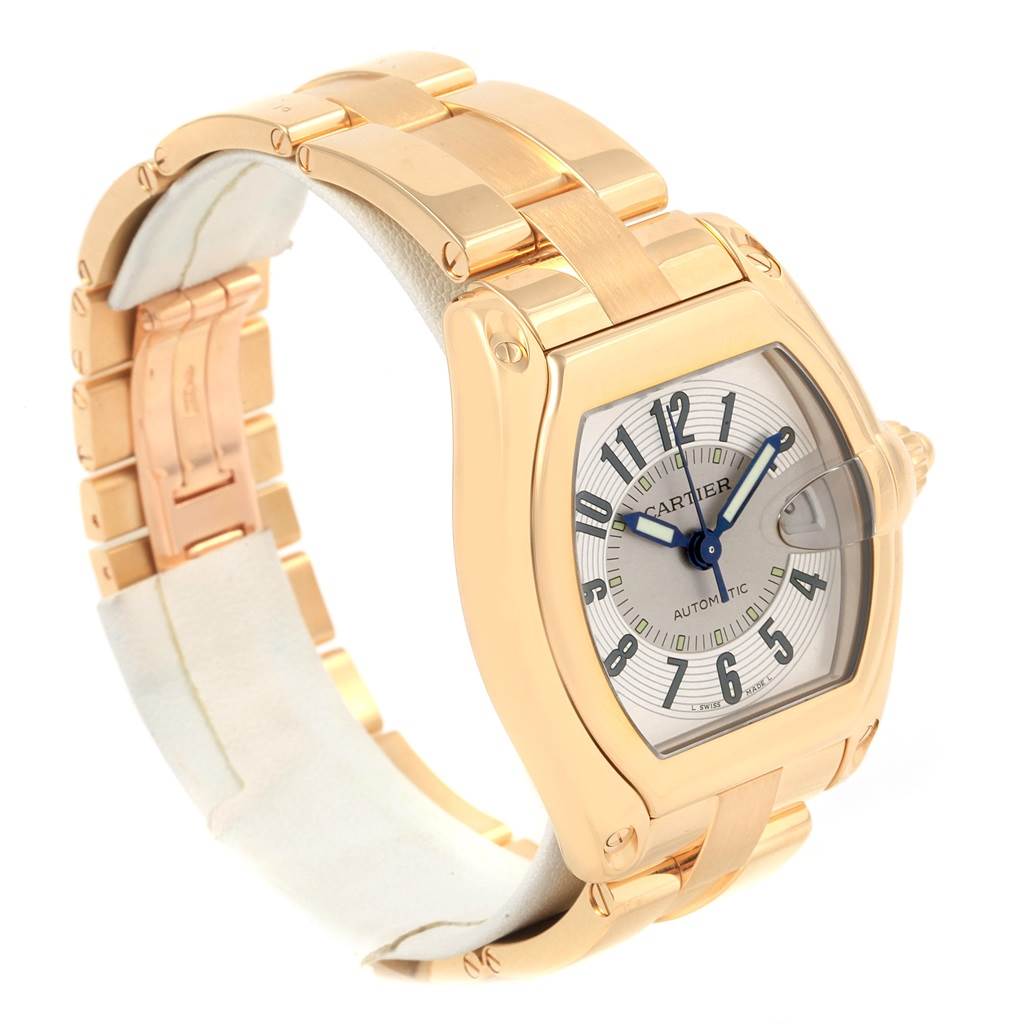 The image shows a Cartier Roadster W62005V1 Men's Yellow Gold Silver Dial W62005V1 Men's Yellow Gold Silver Dial watch at an angle displaying the case, dial, bracelet, and crown.