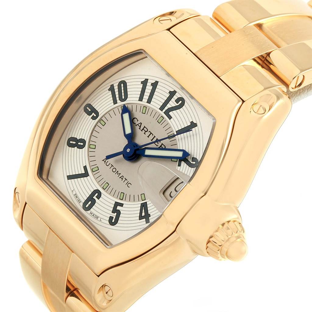 The image shows a close-up of the face, crown, and part of the band of a Cartier Roadster W62005V1 Men's Yellow Gold Silver Dial W62005V1 Men's Yellow Gold Silver Dial watch from a diagonal angle.