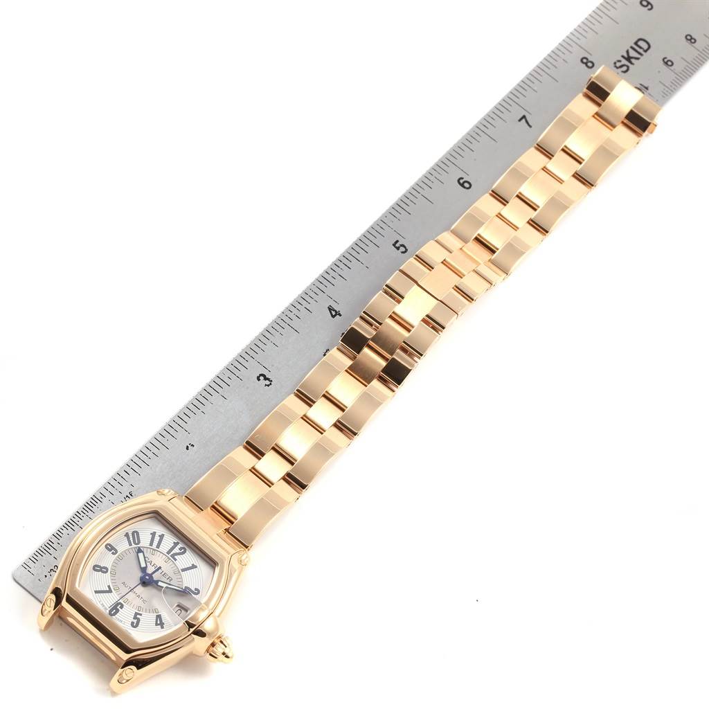 The image shows a Cartier Roadster W62005V1 Men's Yellow Gold Silver Dial W62005V1 Men's Yellow Gold Silver Dial watch laid flat, measured next to a ruler, displaying its face, case, and bracelet.