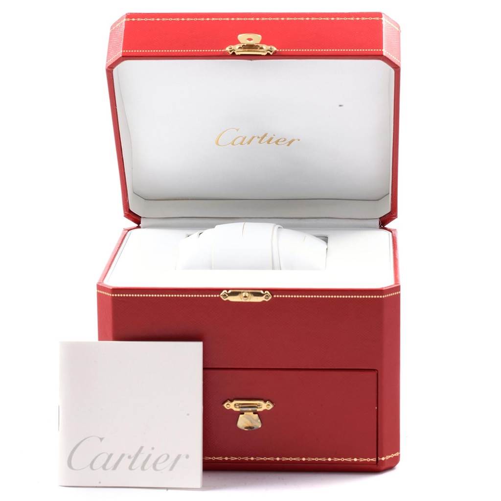 The image shows a Cartier Roadster W62019X6 Men's Stainless Steel Silver Dial W62019X6 Men's Stainless Steel Silver Dial watch inside an open red Cartier box, with a Cartier manual placed beside it.