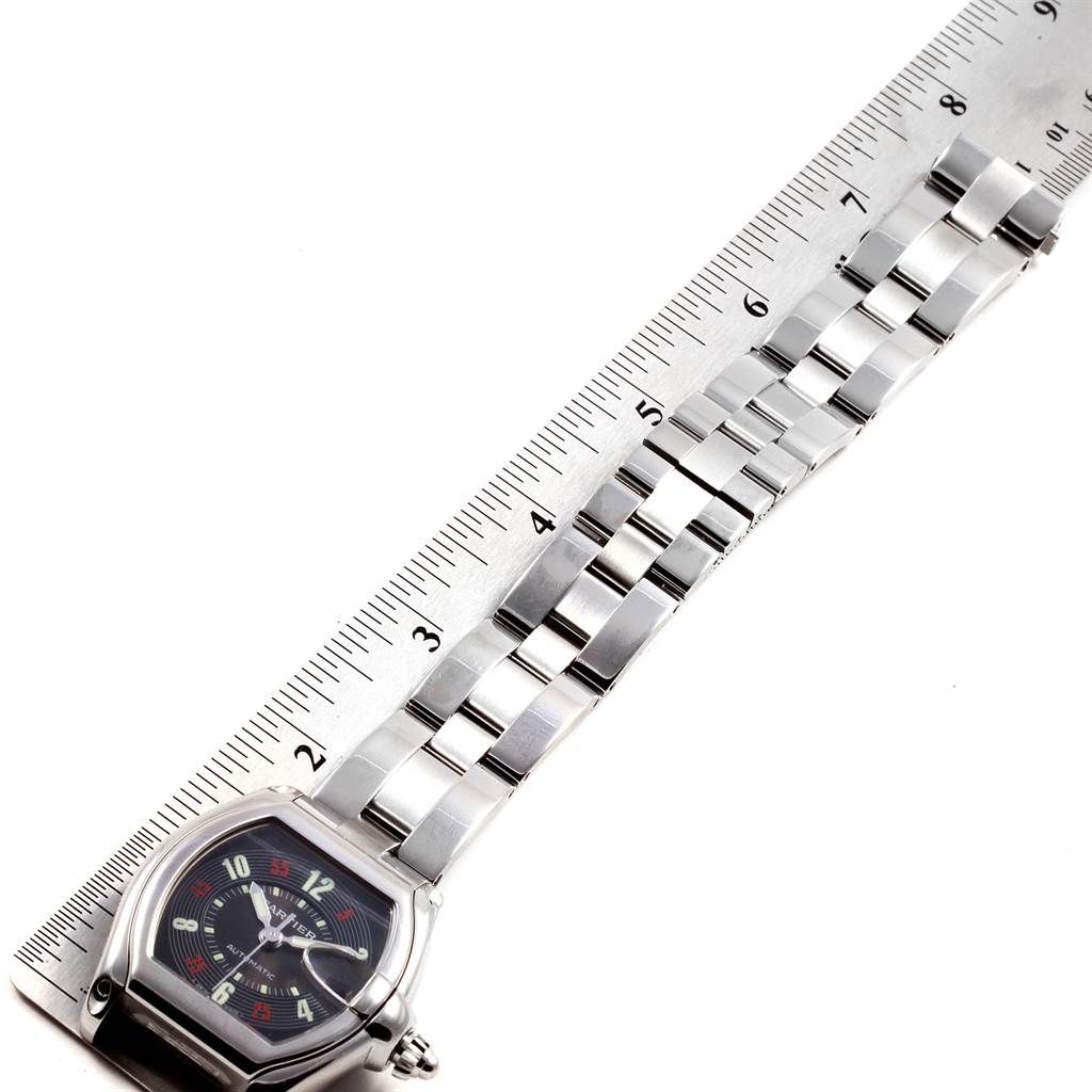 The image shows the Cartier Roadster W62002V3 Men
s Stainless Steel Black Dial W62002V3 Men
s Stainless Steel Black Dial watch, including the face and entire metal band, laid out next to a ruler for measurement.