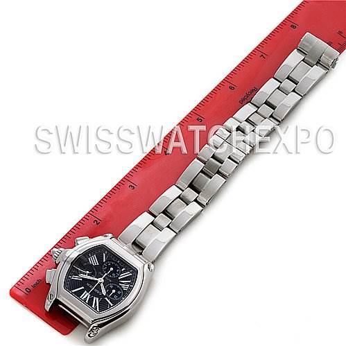 The image shows a Cartier Roadster W62020X6 Men's Stainless Steel Black Dial W62020X6 Men's Stainless Steel Black Dial watch laid flat next to a ruler, displaying its dial and bracelet in full view.