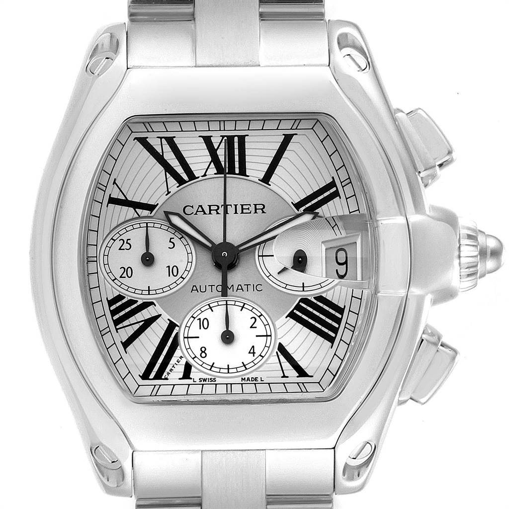The Roadster model by Cartier is shown from the front, displaying its intricate dial, chronograph subdials, date window, and stainless-steel bracelet.