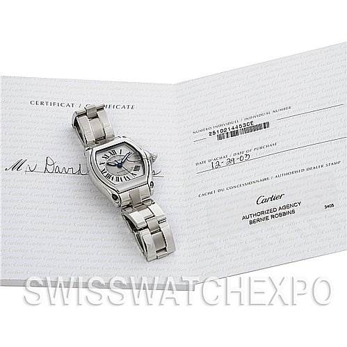 The image shows a Cartier Roadster W62025V3 Men's Stainless Steel Silver Dial W62025V3 Men's Stainless Steel Silver Dial watch placed on an open certificate, displaying the front and bracelet of the watch.