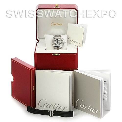 This image shows a Cartier Roadster W62020X6 Men's Stainless Steel Silver Dial W62020X6 Men's Stainless Steel Silver Dial watch in its box, with additional boxes, booklets, and a spare strap set around it.