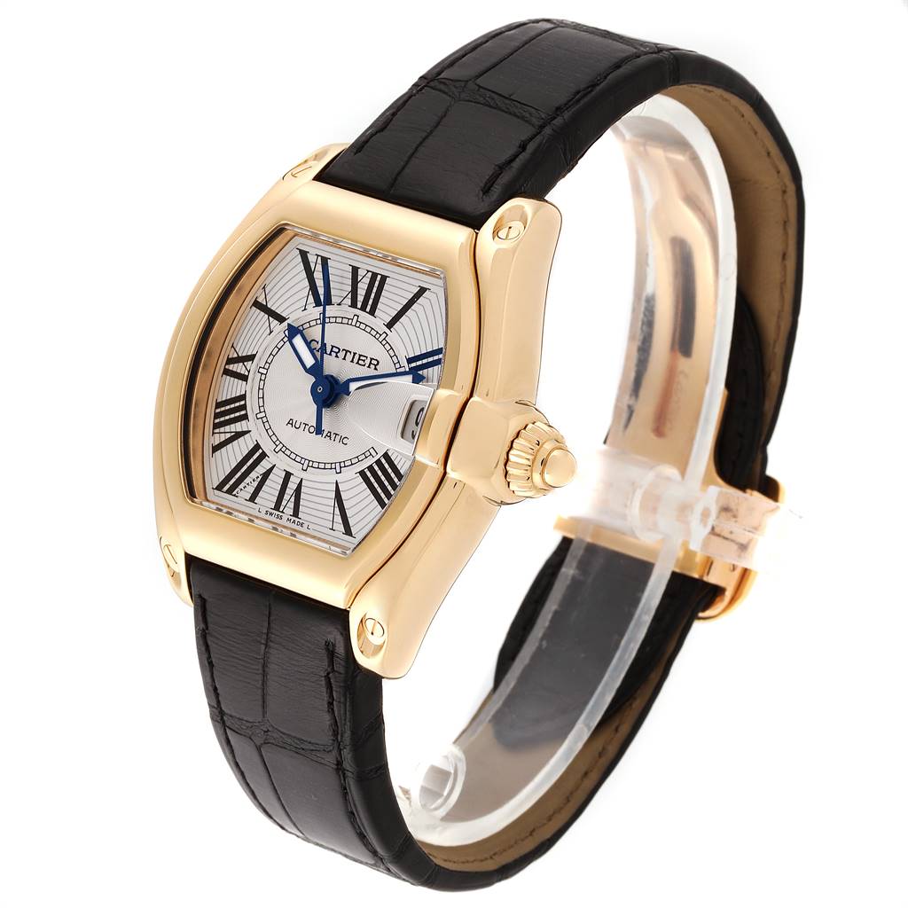 The Cartier Roadster W62005V2 Men's Yellow Gold Silver Dial W62005V2 Men's Yellow Gold Silver Dial watch is shown at an angle displaying the dial, case, crown, and black leather strap.