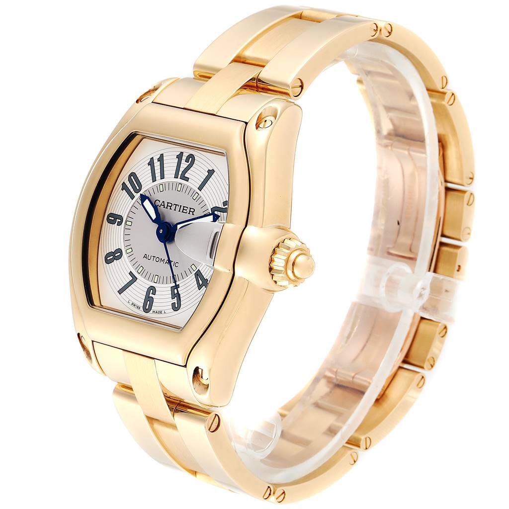 This image shows the Cartier Roadster W62005V1 Men's Yellow Gold Silver Dial W62005V1 Men's Yellow Gold Silver Dial watch at an oblique angle, highlighting its gold casing, bracelet, and silver dial with blue hands.