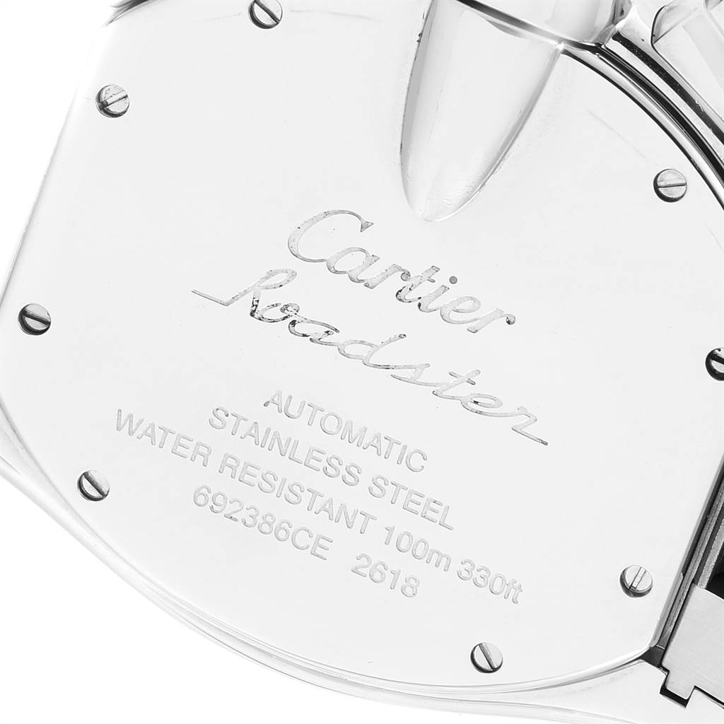 The image shows the case back of the Cartier Roadster W62019X6 Men's Stainless Steel Silver Dial W62019X6 Men's Stainless Steel Silver Dial watch at an angle, highlighting the engraved details and screws.