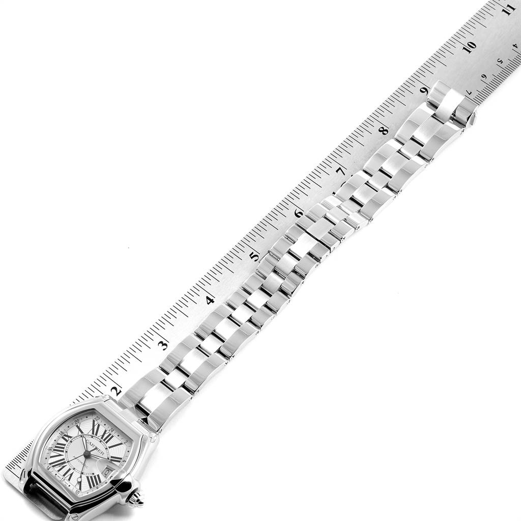 This image shows a top-down view of a Cartier Roadster W62032X6 Men's Stainless Steel Silver Dial W62032X6 Men's Stainless Steel Silver Dial model watch, highlighting its face and metal bracelet against a ruler for scale.