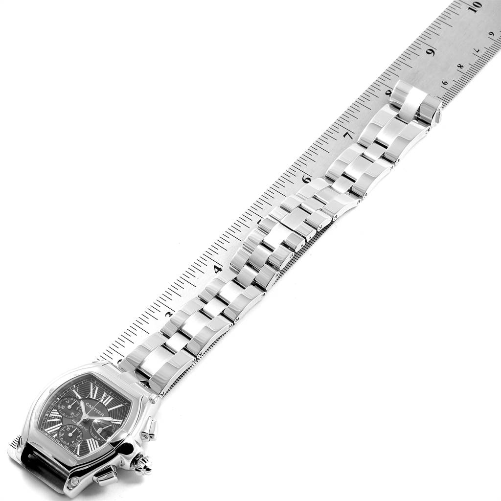 The image shows a Cartier Roadster W62020X6 Men's Stainless Steel Black Dial W62020X6 Men's Stainless Steel Black Dial watch laid flat with a ruler measuring the length of its metal bracelet.