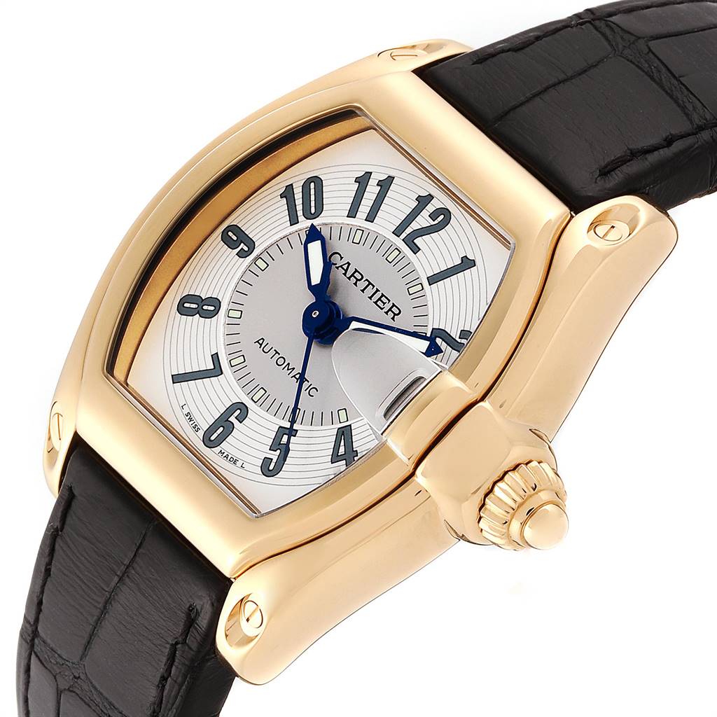The image shows a close-up angle of a Cartier Roadster W62005V2 Men's Yellow Gold Silver Dial W62005V2 Men's Yellow Gold Silver Dial watch, highlighting the dial, case, crown, and strap.