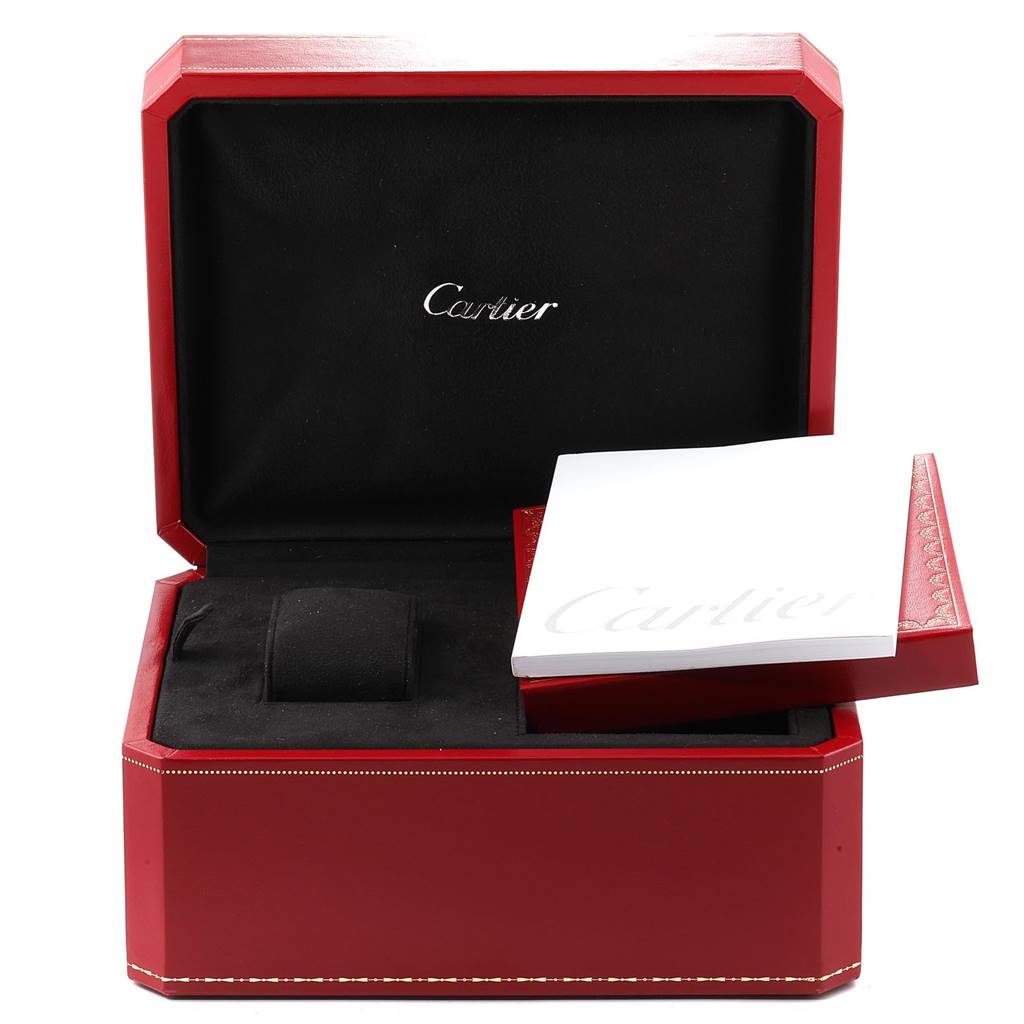 The image shows an open red Cartier watch box with the manual for the Roadster model.