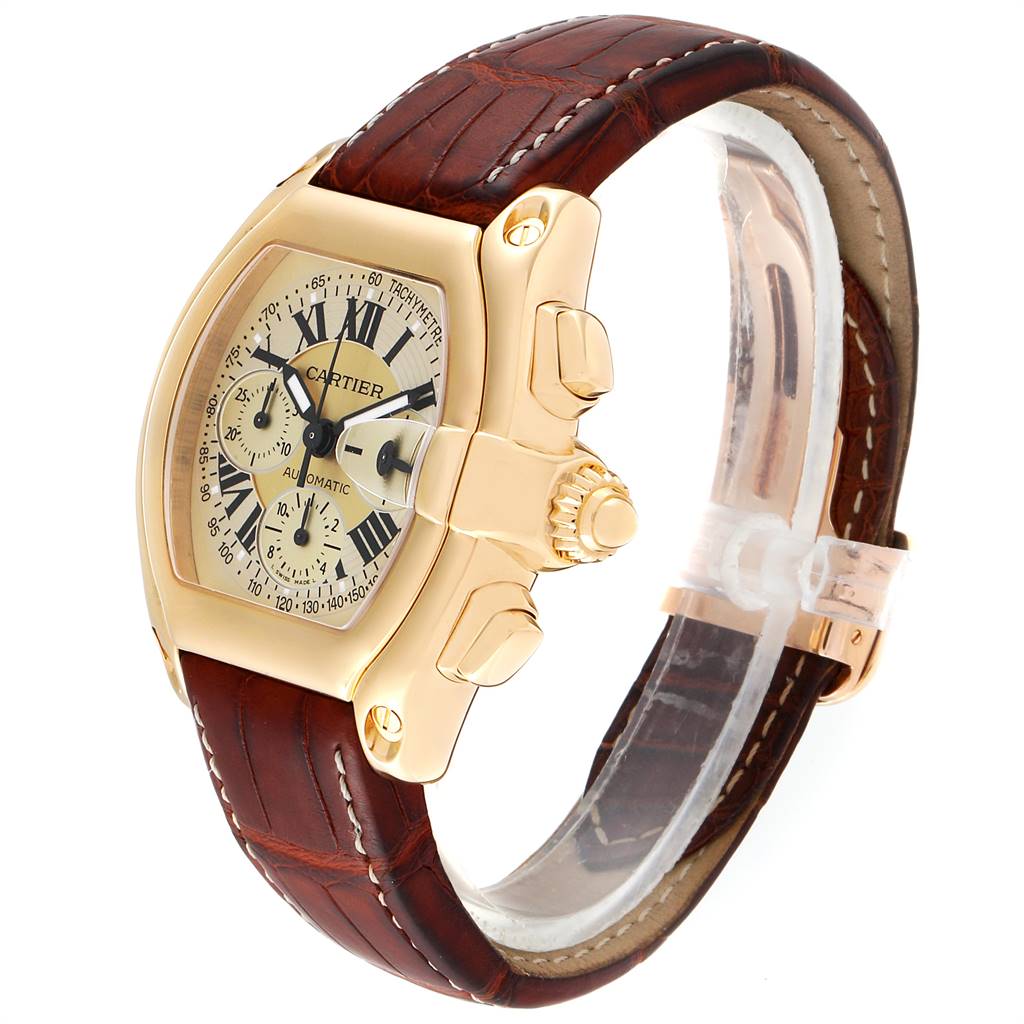 This image shows a side angle view of the Cartier Roadster W62021Y3 Men's Yellow Gold Champagne Dial W62021Y3 Men's Yellow Gold Champagne Dial watch, highlighting its brown leather strap, gold case, and detailed dial.