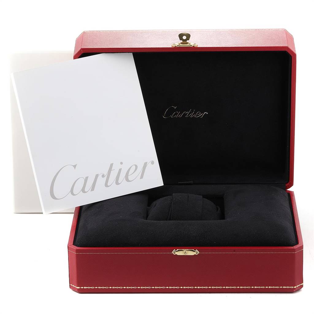The image shows a Cartier Roadster W62005V1 Men's Yellow Gold Silver Dial W62005V1 Men's Yellow Gold Silver Dial watch's red case containing a black cushion and a Cartier booklet.