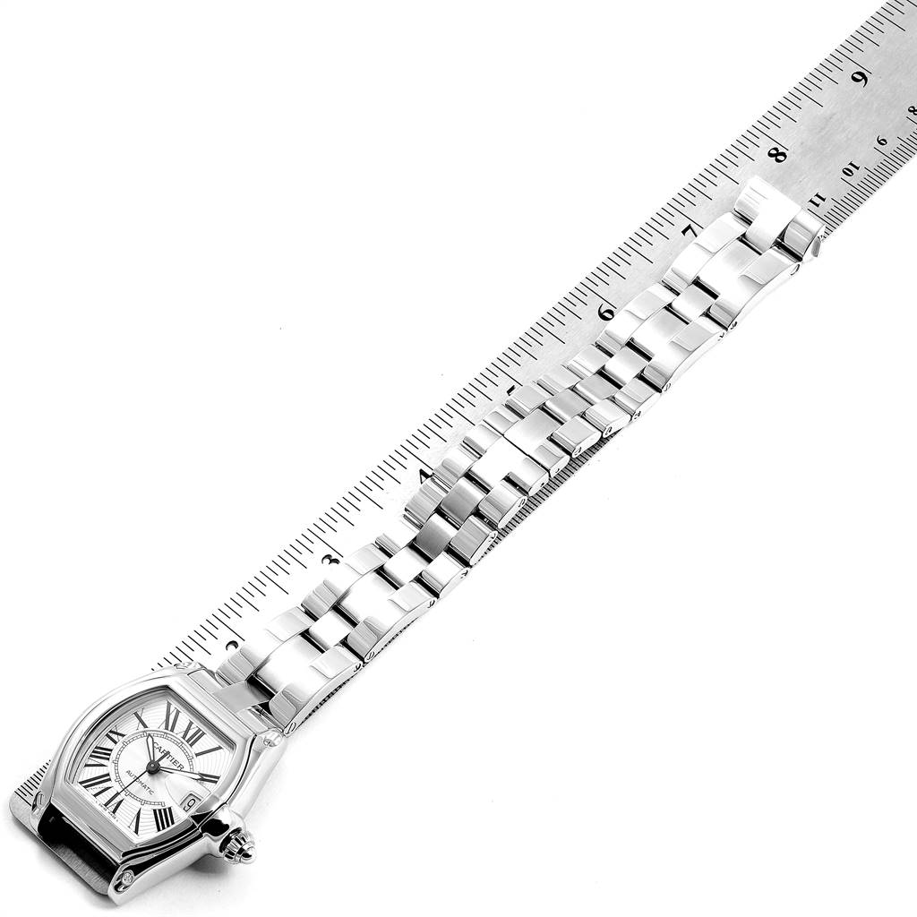 The image shows the Cartier Roadster W62025V3 Men's Stainless Steel Silver Dial W62025V3 Men's Stainless Steel Silver Dial watch lying flat with its strap next to a ruler for measurement.