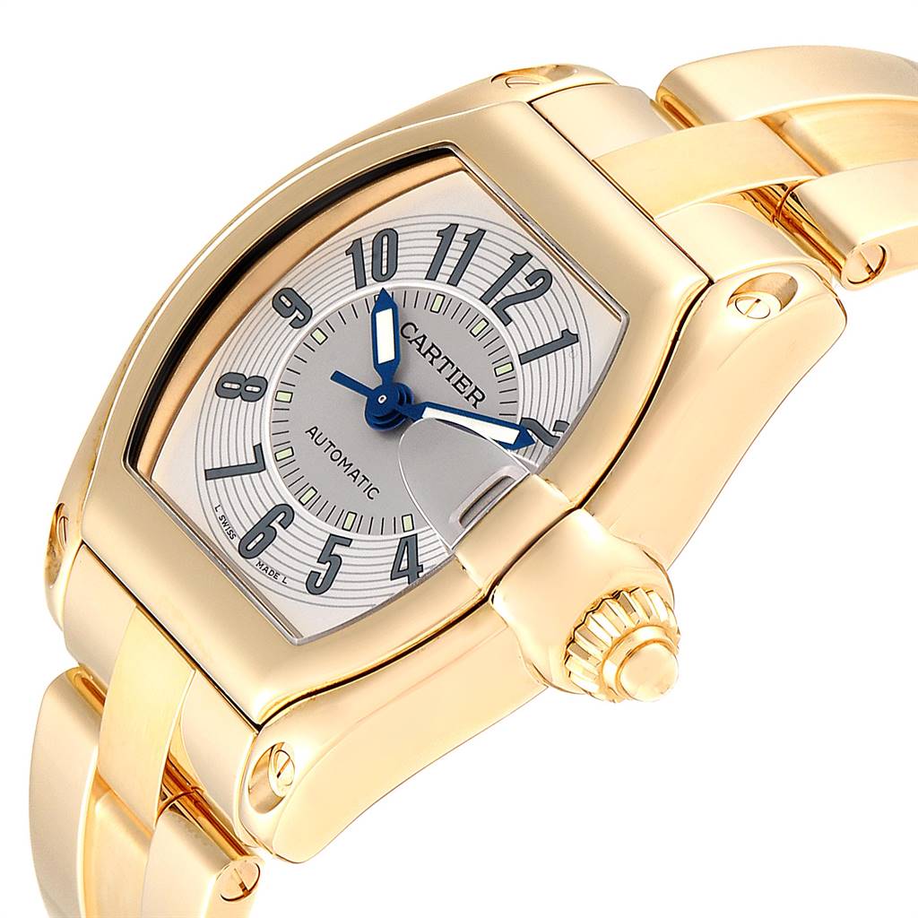 The image shows a Gold Cartier Roadster W62003V1 Men
s Yellow Gold Silver Dial W62003V1 Men
s Yellow Gold Silver Dial model watch from a close-up angle, highlighting the face, crown, and part of the bracelet.
