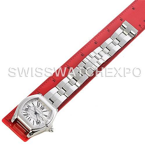 The Cartier Roadster W62032X6 Men's Stainless Steel Silver Dial W62032X6 Men's Stainless Steel Silver Dial watch is shown from above, featuring the face and stainless steel bracelet, lined up against a red ruler.