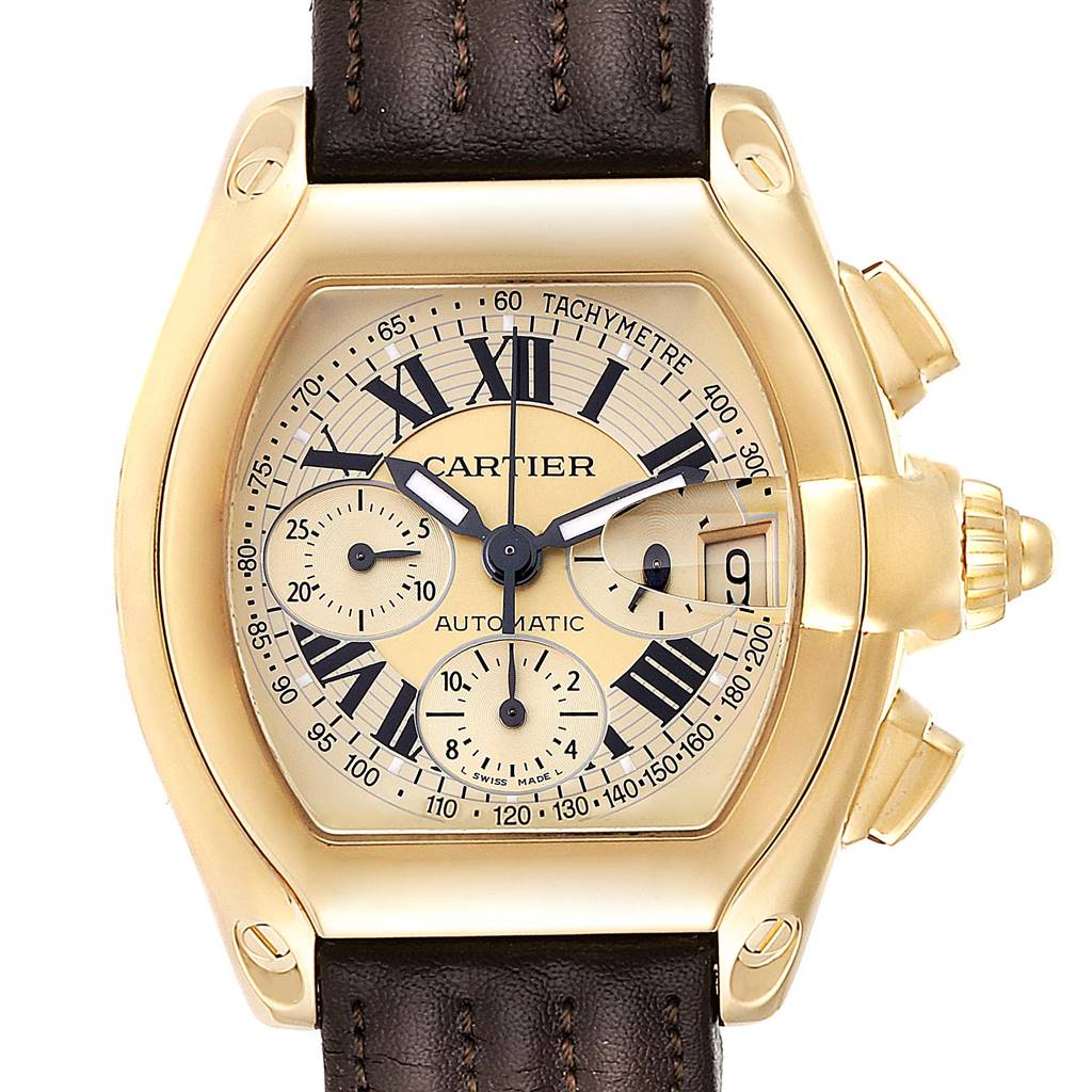 The image shows a frontal view of a Cartier Roadster W62021Y3 Men's Yellow Gold Champagne Dial W62021Y3 Men's Yellow Gold Champagne Dial watch displaying the dial, subdials, tachymeter, and date window.