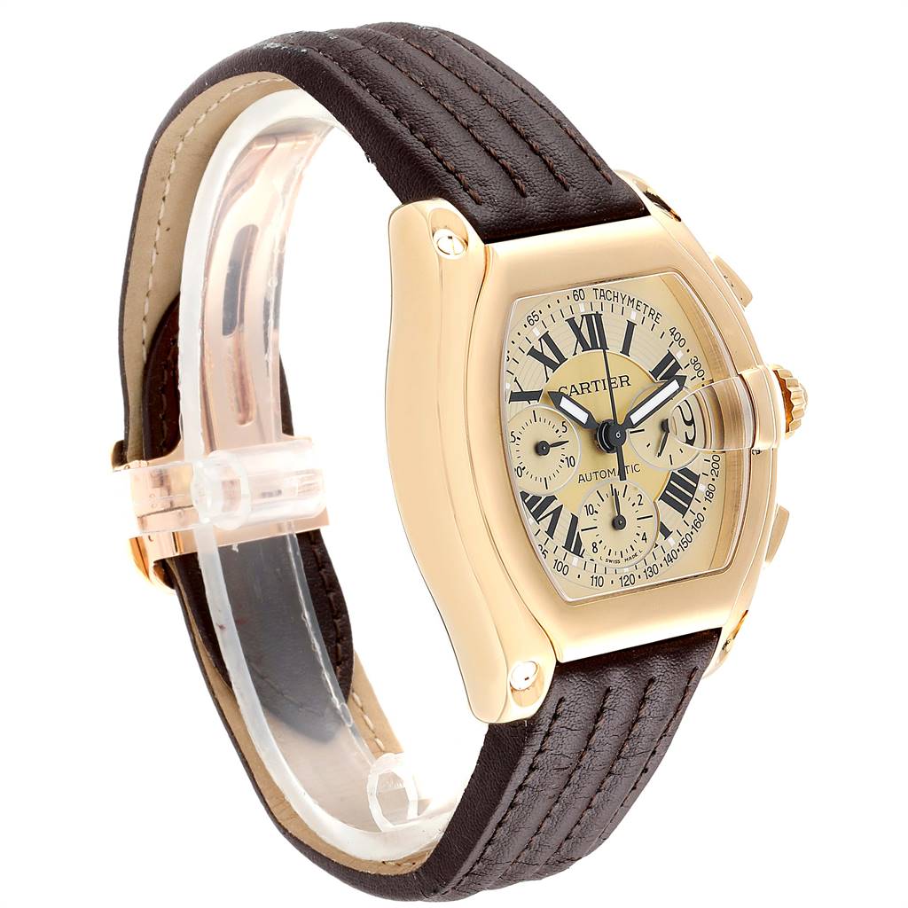 This image shows a Cartier Roadster W62021Y3 Men's Yellow Gold Champagne Dial W62021Y3 Men's Yellow Gold Champagne Dial watch at a three-quarter angle, highlighting its gold case, dial, and leather strap.
