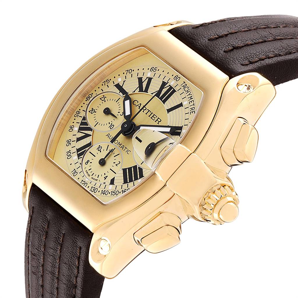 The image shows a Cartier Roadster W62021Y3 Men's Yellow Gold Champagne Dial W62021Y3 Men's Yellow Gold Champagne Dial watch at an angled close-up, highlighting the dial, case, crown, and part of the leather strap.