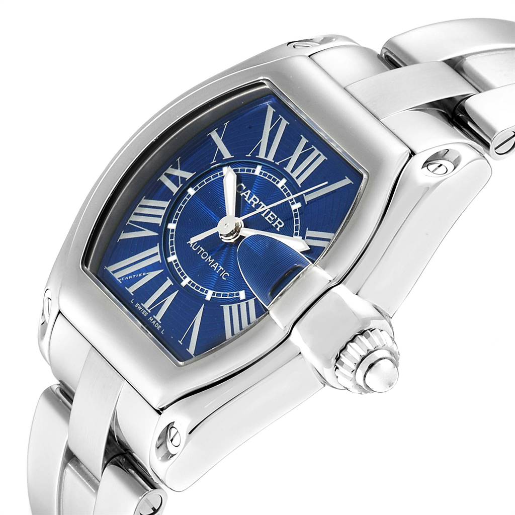 The image shows a close-up side view of the Cartier Roadster W62048V3 Men's Stainless Steel Blue Dial W62048V3 Men's Stainless Steel Blue Dial watch highlighting its blue dial, Roman numerals, and silver metal bracelet.