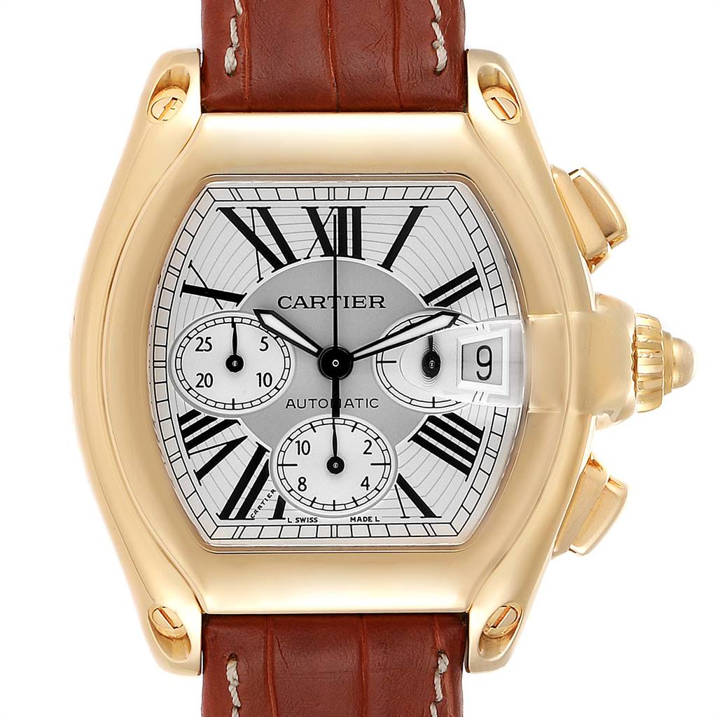 The image shows a front view of a Cartier Roadster W62021Y3 Men's Yellow Gold Silver Dial W62021Y3 Men's Yellow Gold Silver Dial watch with a gold case, brown leather strap, and subdials on the face.