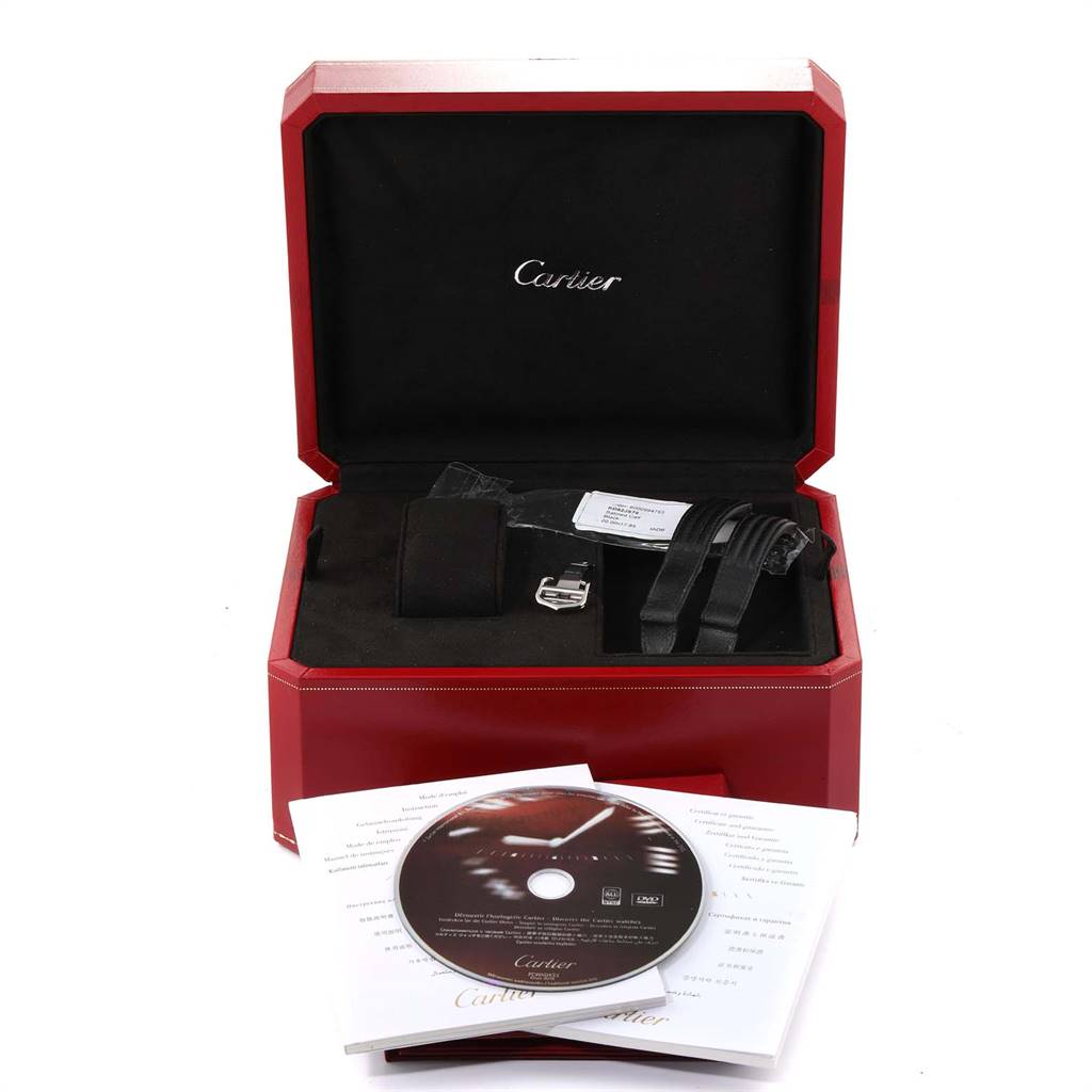 The image shows an open Cartier Roadster W62019X6 Men
s Stainless Steel Silver Dial W62019X6 Men
s Stainless Steel Silver Dial watch box with accessories, including a CD, manuals, and straps, all displayed from a front angle.