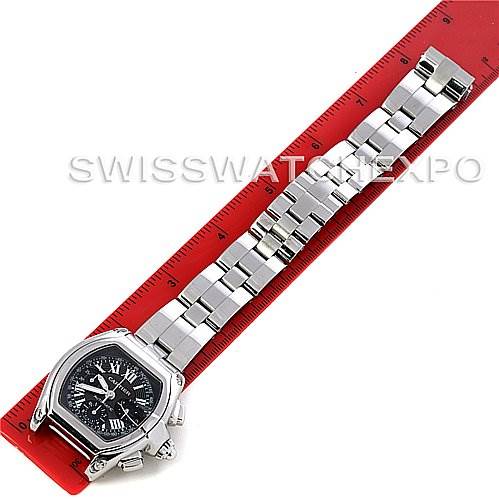 This image shows an overhead view of the Cartier Roadster W62020X6 Men's Stainless Steel Black Dial W62020X6 Men's Stainless Steel Black Dial watch with its entire bracelet stretched out and placed next to a red ruler.