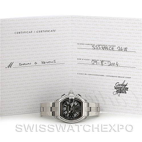 The image shows a Cartier Roadster W62020X6 Men's Stainless Steel Black Dial W62020X6 Men's Stainless Steel Black Dial watch with a metal bracelet, displayed in front of its certificate.