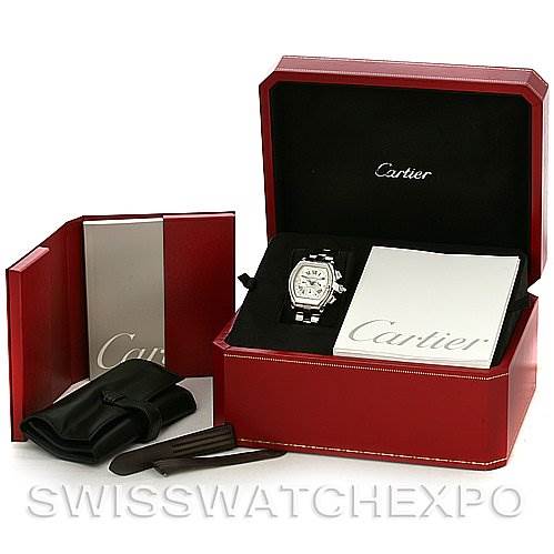 The image shows a Cartier Roadster W62019X6 Men's Stainless Steel Silver Dial W62019X6 Men's Stainless Steel Silver Dial watch at an angle, inside its open red box with additional accessories and booklets.