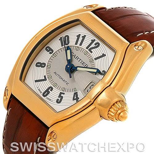 The image shows a Cartier Roadster W62005V2 Men's Yellow Gold Silver Dial W62005V2 Men's Yellow Gold Silver Dial watch at a three-quarter angle, highlighting its dial, case, crown, and brown leather strap.