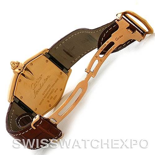 The image shows the back and clasp of a Cartier Roadster W62005V2 Men's Yellow Gold Silver Dial W62005V2 Men's Yellow Gold Silver Dial watch, highlighting its brown leather strap and gold-tone case.