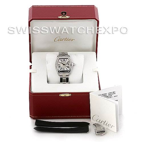 The Cartier Roadster W62025V3 Men's Stainless Steel Silver Dial W62025V3 Men's Stainless Steel Silver Dial watch is displayed in its box, accompanied by booklets, an extra strap, and a metal clasp.
