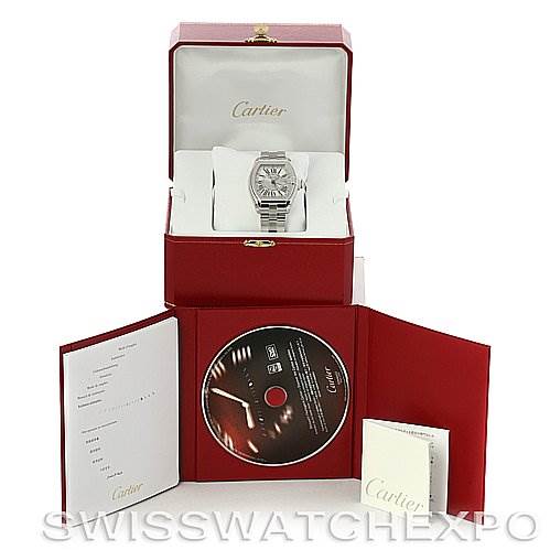 The image shows a Cartier Roadster W62032X6 Men's Stainless Steel Silver Dial W62032X6 Men's Stainless Steel Silver Dial watch in its open box, accompanied by a booklet and a CD.