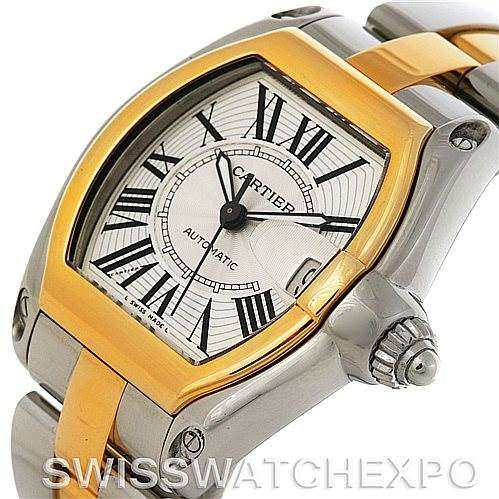 The image shows a close-up of the dial, bezel, and part of the bracelet of the Cartier Roadster W62031Y4 Men's Steel and Gold (two tone) Silver Dial W62031Y4 Men's Steel and Gold (two tone) Silver Dial watch, featuring a gold and stainless steel design.