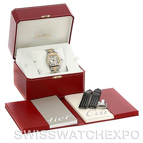 The image shows a Cartier Roadster W62031Y4 Men's Steel and Gold (two tone) Silver Dial W62031Y4 Men's Steel and Gold (two tone) Silver Dial watch, its box, additional straps, and booklets from a front view.