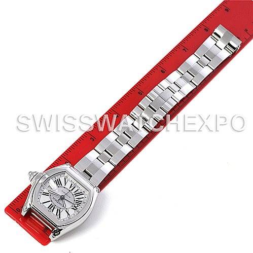 The image shows a Cartier Roadster W62032X6 Men's Stainless Steel Silver Dial W62032X6 Men's Stainless Steel Silver Dial watch lying flat with its full bracelet extended next to a red ruler.