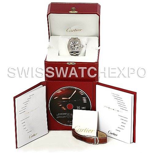The image shows a Cartier Roadster W62032X6 Men's Stainless Steel Silver Dial W62032X6 Men's Stainless Steel Silver Dial watch with its box, manuals, a CD, and an additional leather strap from a front angle.