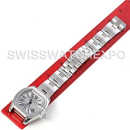 The Cartier Roadster W62032X6 Men's Stainless Steel Silver Dial W62032X6 Men's Stainless Steel Silver Dial watch is displayed flat with its entire bracelet extended on a red ruler.