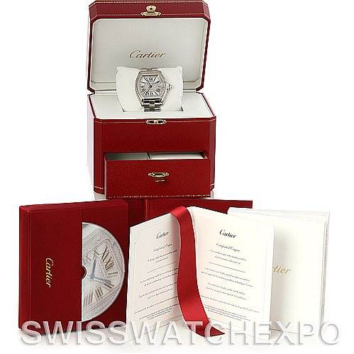 The image shows a Cartier Roadster W62032X6 Men's Stainless Steel Silver Dial W62032X6 Men's Stainless Steel Silver Dial model watch with its box, user manuals, and warranty card placed in front of the watch box.