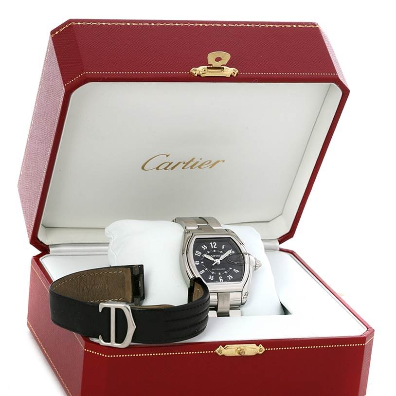 The Cartier Roadster W62004V3 Men's Stainless Steel Black Dial W62004V3 Men's Stainless Steel Black Dial watch is displayed inside its red case, showing its face, bezel, and a detached leather strap.