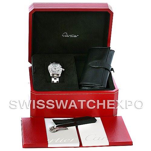 The image shows an open Cartier Roadster W62032X6 Men's Stainless Steel Silver Dial W62032X6 Men's Stainless Steel Silver Dial watch box with the watch, a strap, buckle, and accompanying accessories.