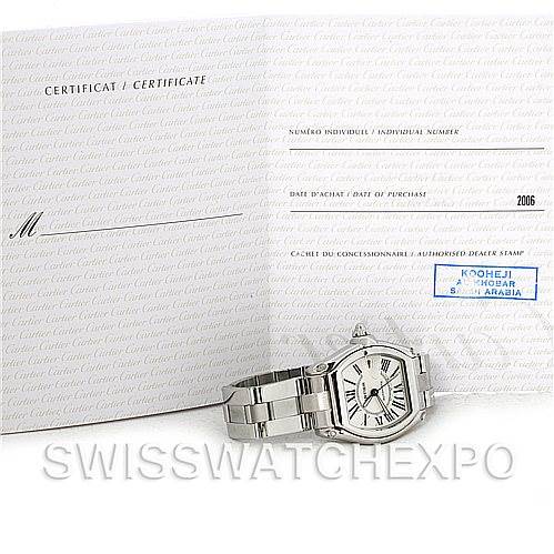 The image shows a Cartier Roadster W62025V3 Men's Stainless Steel Silver Dial W62025V3 Men's Stainless Steel Silver Dial watch with a metal bracelet, angled to display the dial and bracelet, alongside a certification booklet.