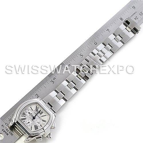 The image shows a top-down view of the Cartier Roadster W62019X6 Men's Stainless Steel Silver Dial W62019X6 Men's Stainless Steel Silver Dial watch with its stainless steel bracelet extended along a ruler for scale.